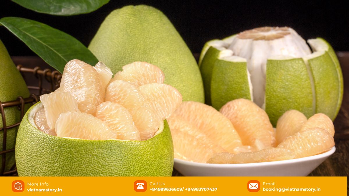 Large green Pomelo fruit, partially peeled to show thick white pith and pale yellow flesh segments.