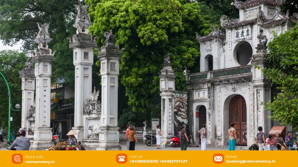 The architectural style of Quan Thanh Temple with its traditional curved roof and intricate details